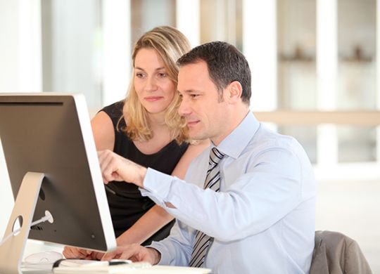 Office workers in front of computer