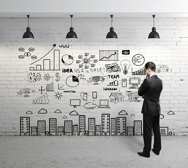 businessman looking at business concept on wall