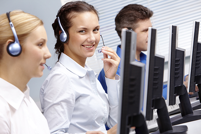 Business team of operators sitting at the table during telephone conversation