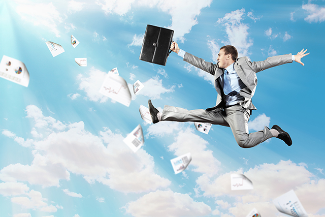 Image of a businessman jumping high against blue sky background